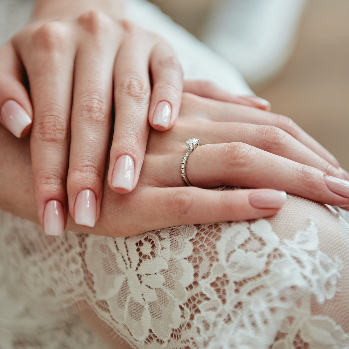Close up of woman hands with pastel wedding manicure, copy space